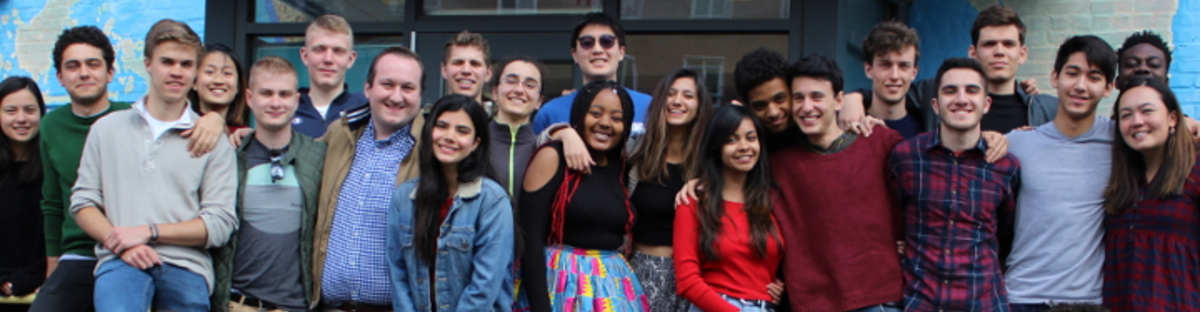 A group of students in front of the Office of International students & Scholars